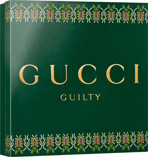 Gucci Guilty parfumverpakking met decoratief patroon op een groene achtergrond.