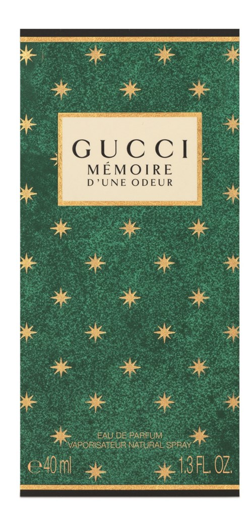 Grön låda med guldstjärnor, vitt märke i mitten, text för Gucci parfym, 40 ml och 1,3 fl oz.