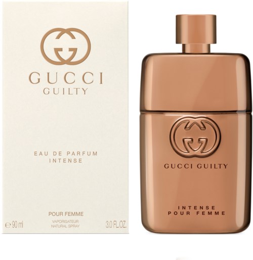 En Gucci Guilty parfyllare och förpackning, med ett guldfärgat glasflaska och elegant vit förpackning.