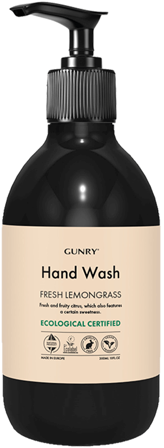 En svart flaske med pumpe merket 'Hand Wash,' inneholder frisk sitrongressduft, økologisk sertifisert, med ikoner for ingredienser.