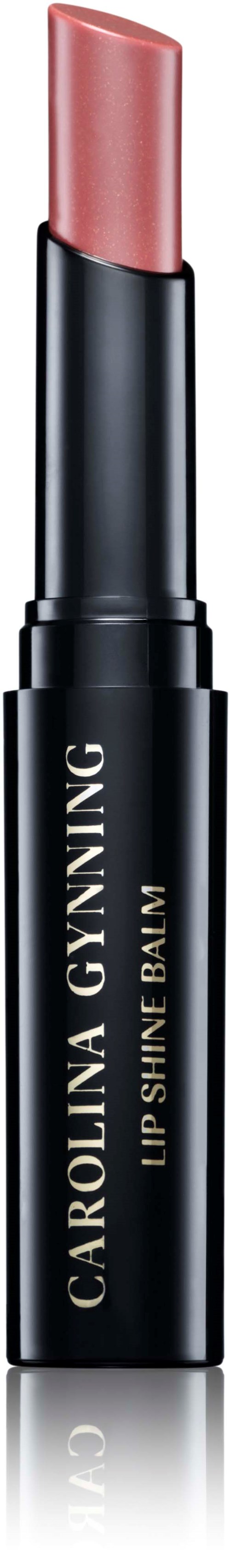 Szminka w czarnym metalowym opakowaniu z beżową pokrywką, oznaczona "Carolina Gynning Lip Shine Balm."