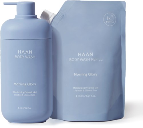 En blå flaske og genopfyldningspakke til HAAN Body Wash med morgenblomster duft, mærket som fugtgivende probiotisk gel.