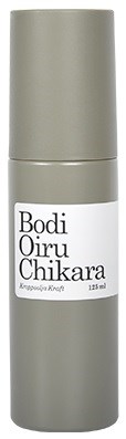 A light gray cylindrical bottle with a white label that has black text, indicating a skincare product.