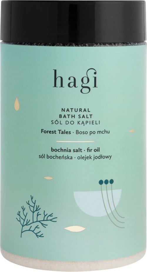 En turkos behållare med svart lock, märkt 'hagi' för badsalt, med minimalistiska havs- och växtillustrationer.
