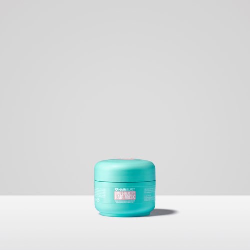 A blue container labeled for hair mask, simple with a plain background, placed on a flat surface.