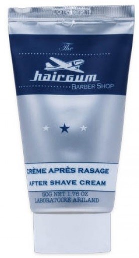 En tube med aftershavekrem fra Hairgum Barber Shop. Den er blå og hvit med merke og størrelsesdetaljer.