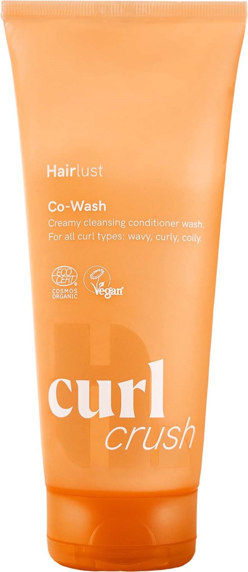 Een oranje tube van Hairlust Curl Crush co-wash met productnaam en beschrijving voor krullend haar.
