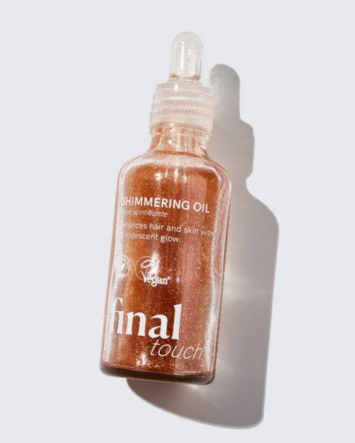 Kleine glazen fles met glanzende haar- en huidolie met pipetdop, gelabeld Final Touch, Veganistisch, Schitterende olie.