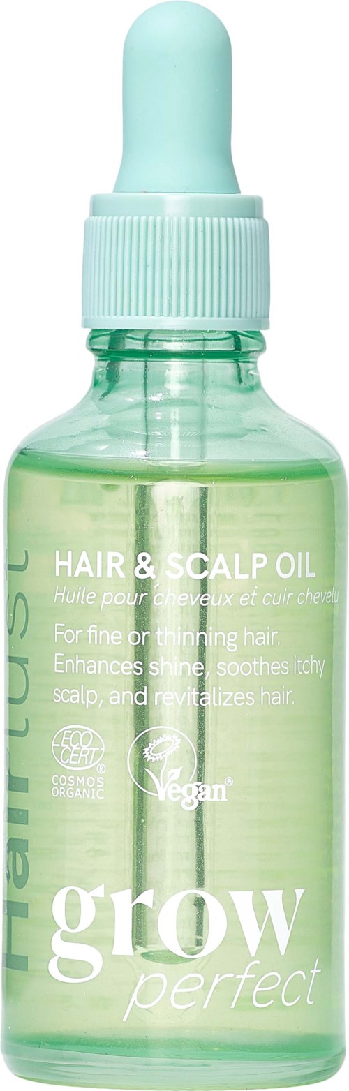 Een kleine groene glazen fles met schroefdop en pipet, gelabeld als haar- en hoofdhuidolie voor haarverzorging.
