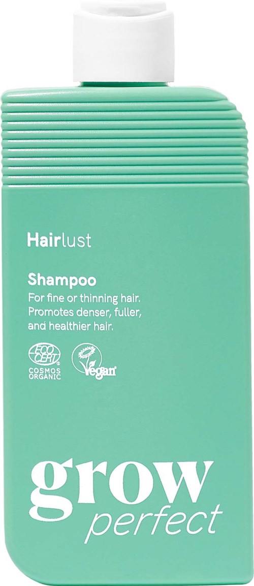 Groene shampoo fles met witte dop, gelabeld Hairlust Grow Perfect voor fijn of dun haar met eco- en veganistische iconen.
