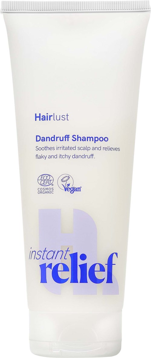White tube of dandruff shampoo with blue and purple text and icons indicating vegan and organic ingredients.