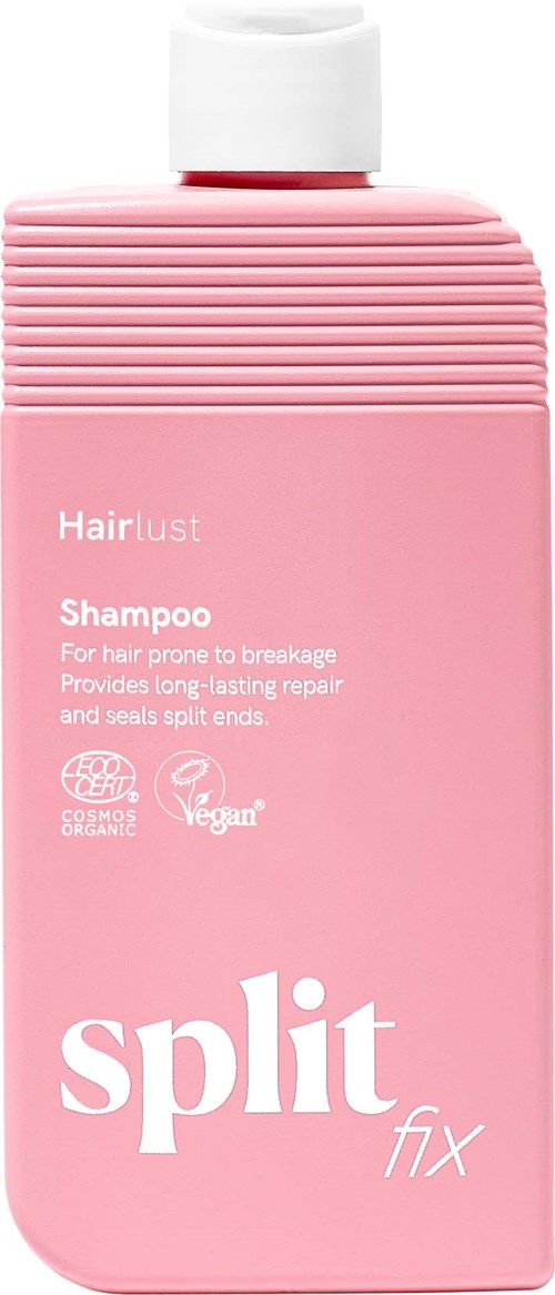 Ljusrosa schampo-flaska med vit lock och ribbad topp. Text på flaskan säger Hairlust Schampo för hårbrott och helande.