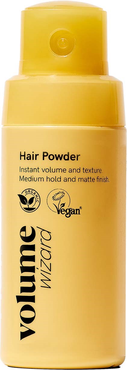 Yellow bottle of volumizing hair powder with a pump, labeled as vegan, offering instant volume and matte finish.