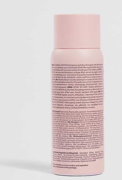 Een roze cilindervormige fles met dop, bevat shampoo of haarverzorgingsproduct.