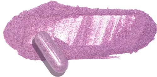 A pink pill and lipstick swatch on a black background.