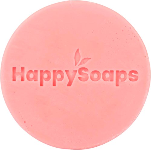 Rund rosa tvål med inristat 'Happy Soaps' och ett blad ovanför texten.