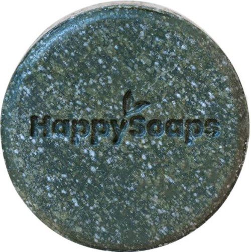 En rund, grønnaktig såpe med små hvite prikker og ordet "HappySoaps" preget inn.
