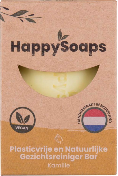En tvålkbox med ett leende ansiktsdesign, märkt 'HappySoaps', med naturliga ingredienser och veganska produktdetaljer.
