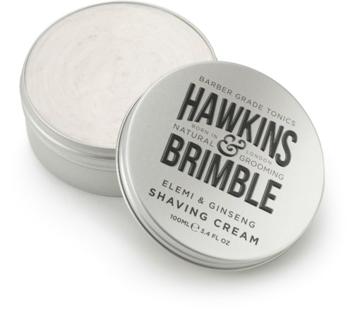 En rund burk med lock som visar, märkt Hawkins & Brimble rakkräm med naturliga ingredienser.