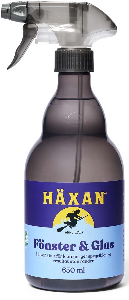 Eine graue Sprayflasche mit schwarzem Deckel und blauer Beschriftung, die "HÄXAN Förnster & Glas" sagt.