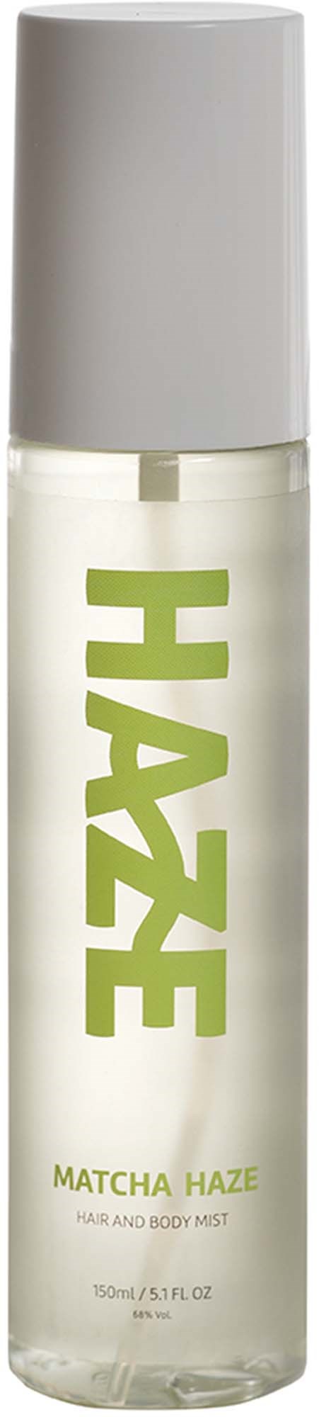 En gennemsigtig sprayflaske med hvid hætte og grøn tekst med HAZE og MATCHA HAZE, hår- og kropsmist.
