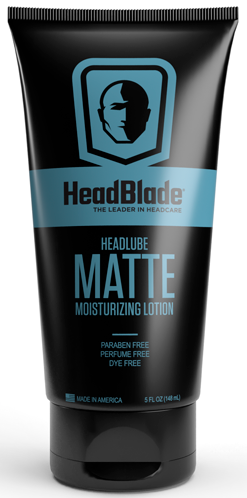 En sort tube med blå mærkat med en hovedsilhuet og produktnavnet HeadBlade Matte, fugtighedscreme til hovedet.