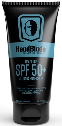 En sort tube viser HeadBlade logo, produktnavn, SPF 50+ solcreme og beskrivelse til hoved- og hudbeskyttelse.