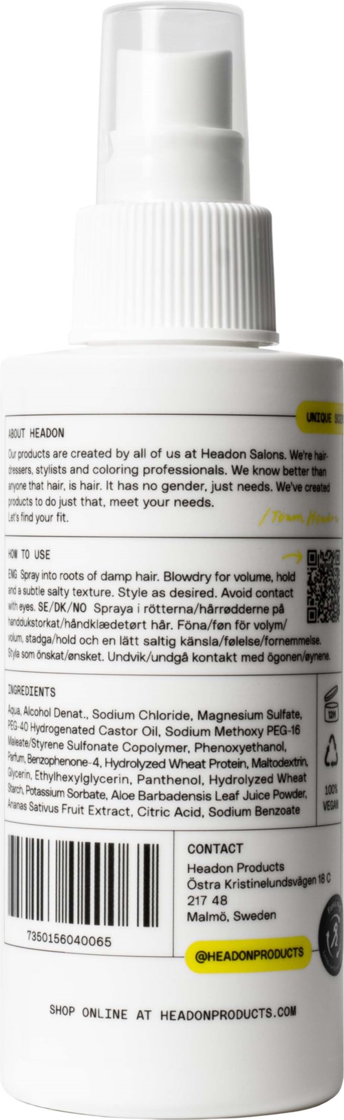 Det är en vit sprayflaska med spraymunstycke, visande produktinformation och ingredienser på etiketten.