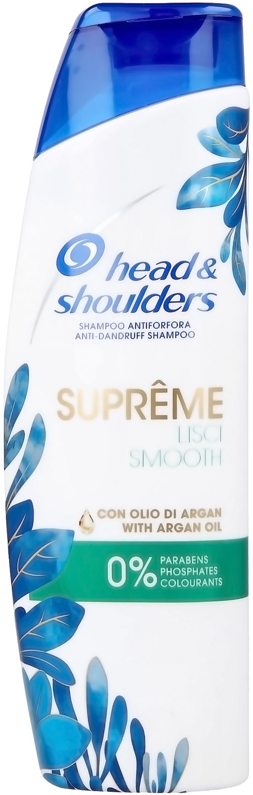 En lang sjampo-flaske med hvit og blå farger, merket "head & shoulders" og "SUPRÈME". Den nevner arganolje og ingen parabener.