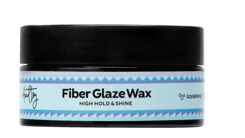 En liten burk märkt 'Fiber Glaze Wax' med svart lock, används för hårstyling för glans och stadga.