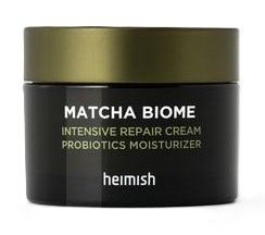 En svart förpackning med grönt lock, märkt 'MATCHA BIOME' för fuktkräm med probiotika, av Heimish.