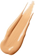 En beige vätska med en slät, krämig konsistens som är utbredd på en vit bakgrund.