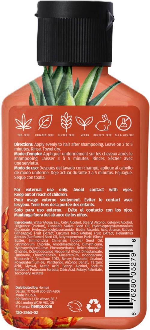 A bottle with a pineapple and leaf design, containing shampoo for hair, with washing instructions on the label.