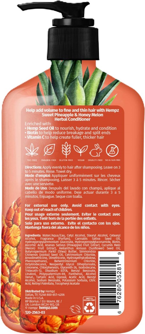 A coral-colored shampoo bottle with a pineapple and honey melon design, detailed text, and a black pump top.