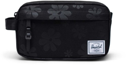 A black Herschel bag with gray flower patterns and a white label. It has a zipper and a small side strap.