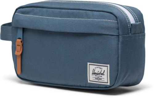 A blue toiletry bag with a zipper, handle, and a label on the front. It looks compact and suitable for travel.