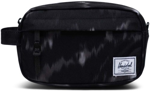 A black Herschel toiletry bag with a small rectangle logo on the front, made of shiny and matte material.