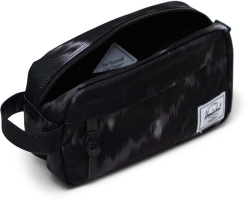 A black pencil case with a zipper, label, and two compartments, made of shiny fabric.
