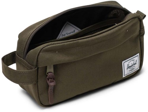 A green travel bag with a zipper, a handle on the side, and a label on the front.