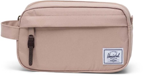 A beige Herschel toiletry bag with a front zipper pocket, logo tag, and a side handle.
