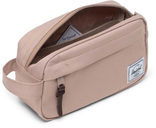 A beige bag with a zipper and handle, open showing a small inside pocket and a label on the front.