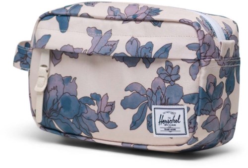 A floral patterned Herschel toiletry bag in light colors with a front pocket and a logo label.