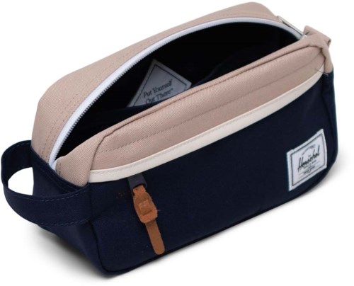 A navy blue and beige bag with a zip, a handle, and a label on the front.