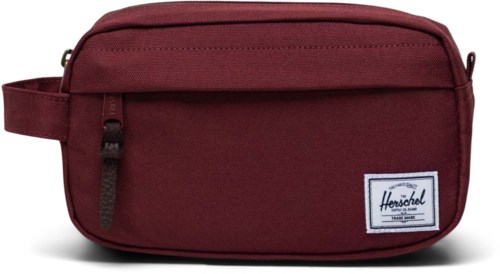 A maroon Herschel brand toiletry bag with a zipper and a small front pocket.