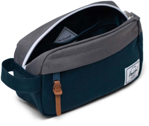 A navy blue and gray bag with zippers and a small patch on the side. It has a handle and looks spacious.