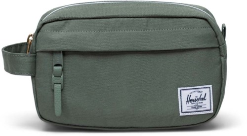 Green Herschel bag with a front pocket, zipper, and label patch on the lower right corner.
