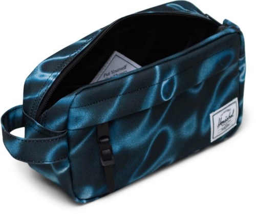A blue bag with a black zipper, handle, and a small white label, sitting against a white background.