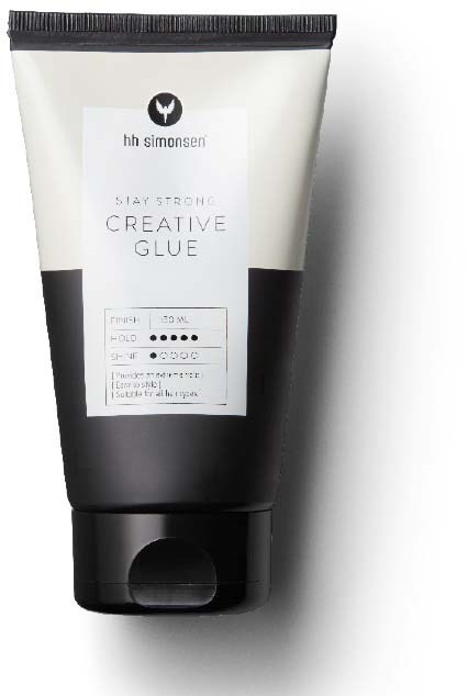 En svart och vit tub med texten 'Stay Strong Creative Glue' och en logo.