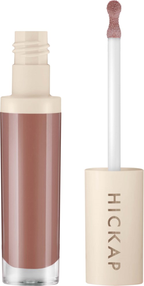 En flytende leppefarge med beige lokk og en brunsnygg leppefarge inni. Påføreren er en børste med en svampetopp.