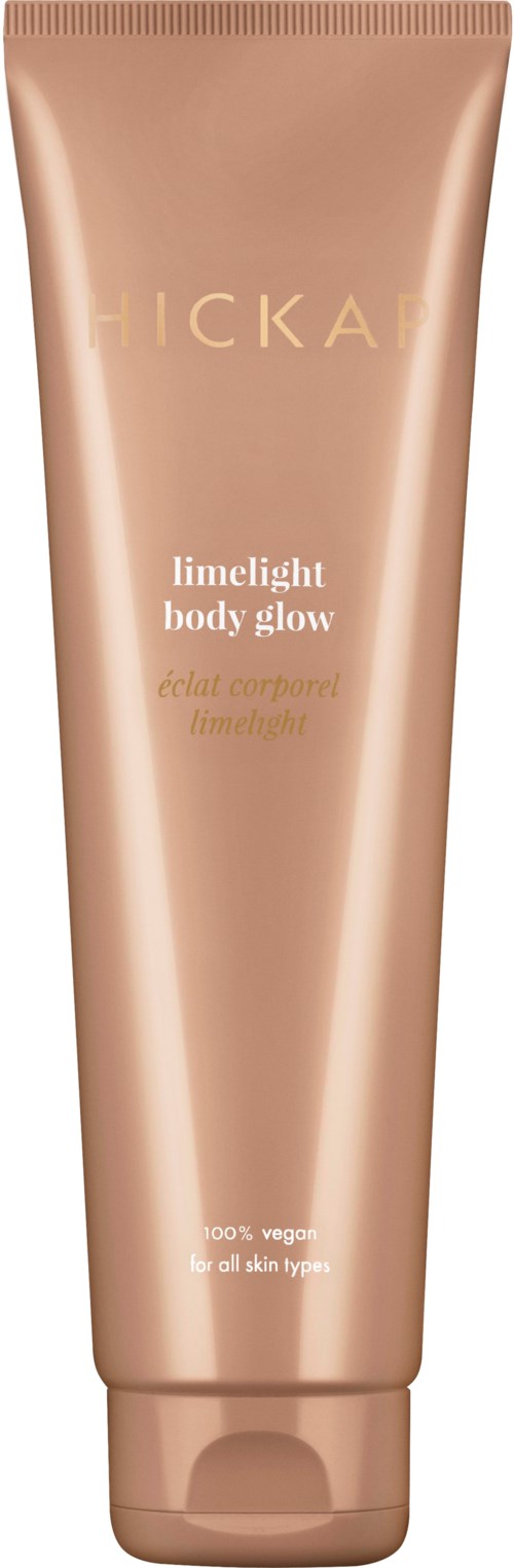 En ferskenfarget tube av FICKA Limelight Body Glow med gull- og hvit tekst, står oppreist.
